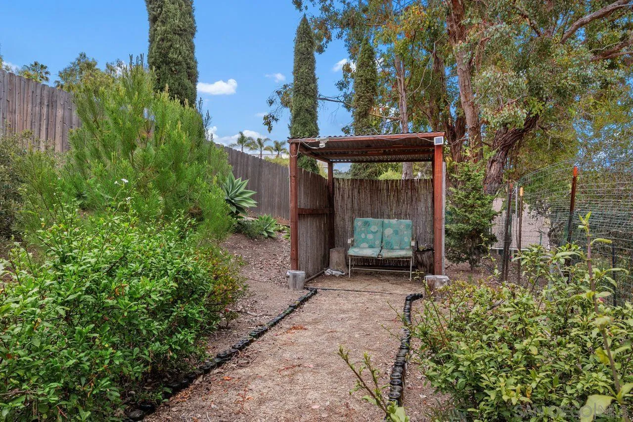 2238 Oceanview Road Oceanside, CA 92056 - Photo 22 of 50 a view of a house with a small yard and a large tree