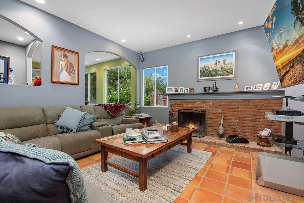 2238 Oceanview Road Oceanside, CA 92056 - Photo 31 of 50 a living room with furniture a large window and a fireplace