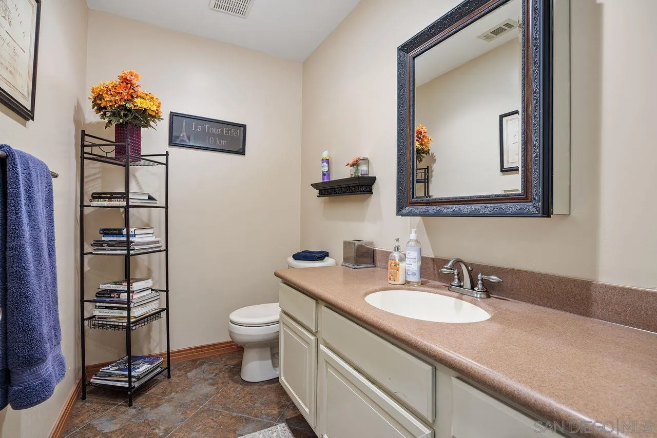 2238 Oceanview Road Oceanside, CA 92056 - Photo 33 of 50 a bathroom with a toilet a sink and mirror