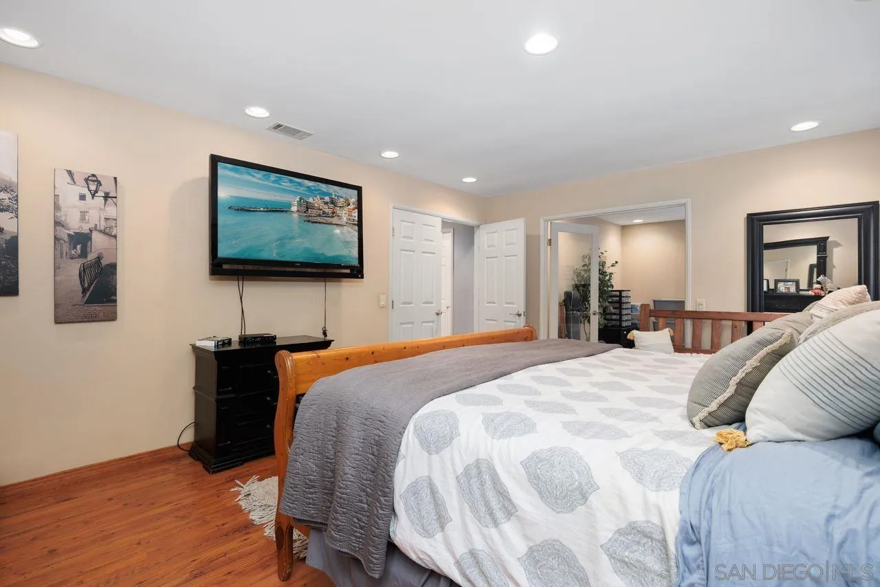 2238 Oceanview Road Oceanside, CA 92056 - Photo 36 of 50 a spacious bedroom with a bed and a flat screen tv
