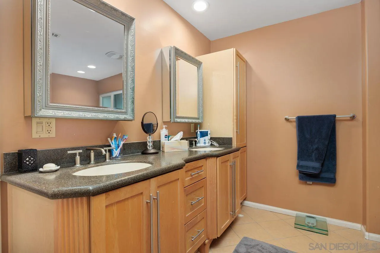2238 Oceanview Road Oceanside, CA 92056 - Photo 38 of 50 a bathroom with a sink and a mirror