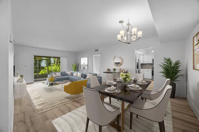 a view of a dining room with furniture a chandelier and wooden floor