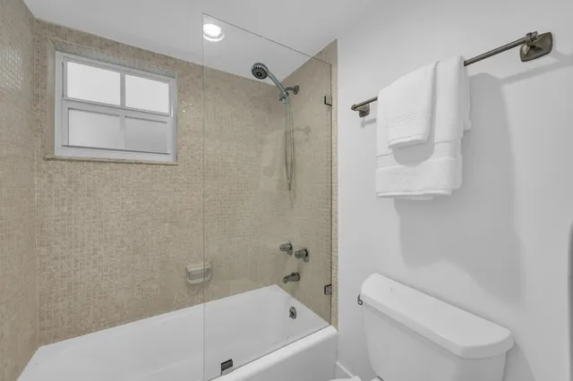 a bathroom with a toilet and a bathtub