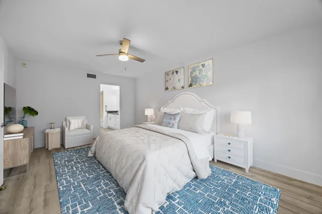 a bedroom with a large bed and a chandelier
