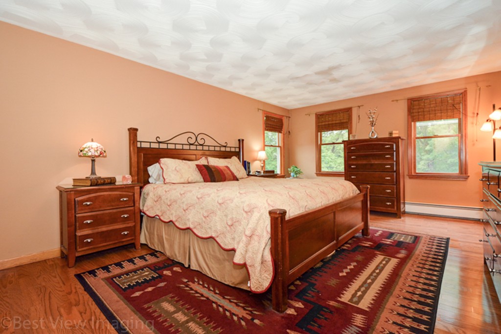 230 Stone School Road Sutton, MA 01590 - Photo 13 of 27 a bedroom with a bed and wooden floor