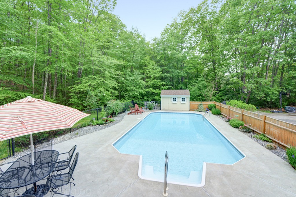 230 Stone School Road Sutton, MA 01590 - Photo 23 of 27 a view of a swimming pool with a patio