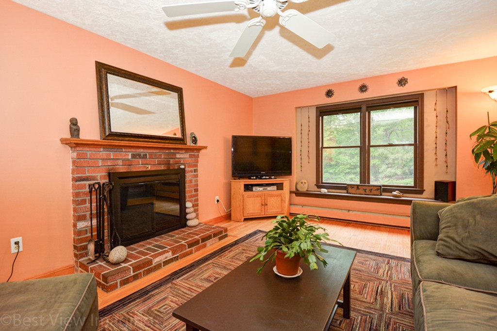 230 Stone School Road Sutton, MA 01590 - Photo 4 of 27 a living room with furniture a flat screen tv and a fireplace