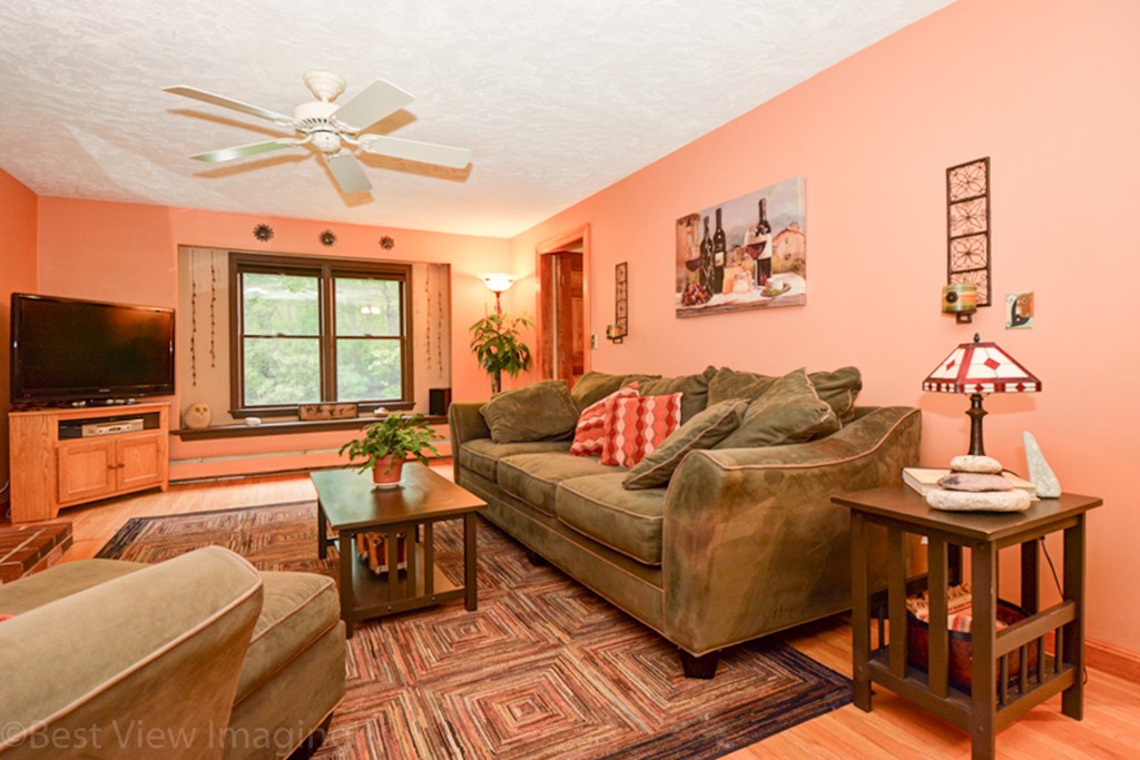 230 Stone School Road Sutton, MA 01590 - Photo 5 of 27 a living room with furniture a flat screen tv and a window