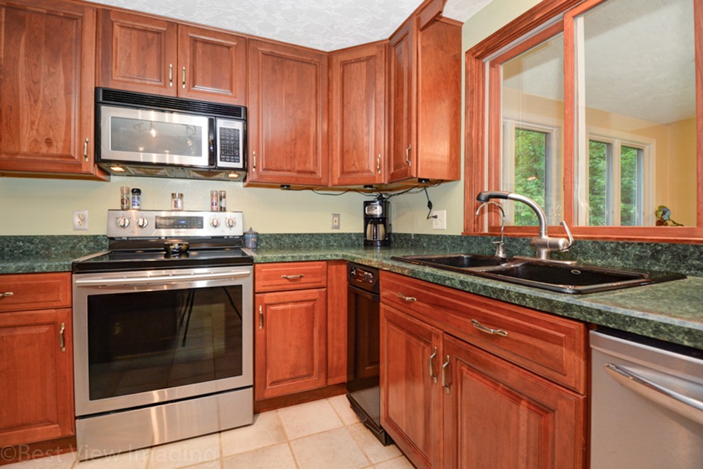 230 Stone School Road Sutton, MA 01590 - Photo 7 of 27 a kitchen with stainless steel appliances granite countertop a stove microwave and sink