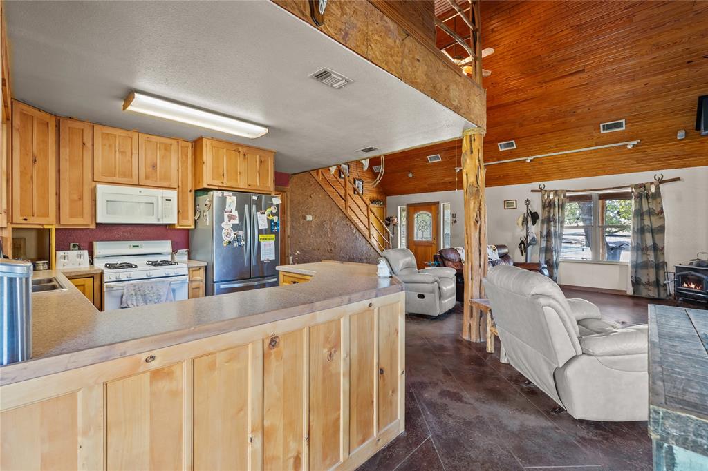 262 North Cheyenne Springtown, TX 76082 - Photo 11 of 35 a living room with furniture a flat screen tv and large window