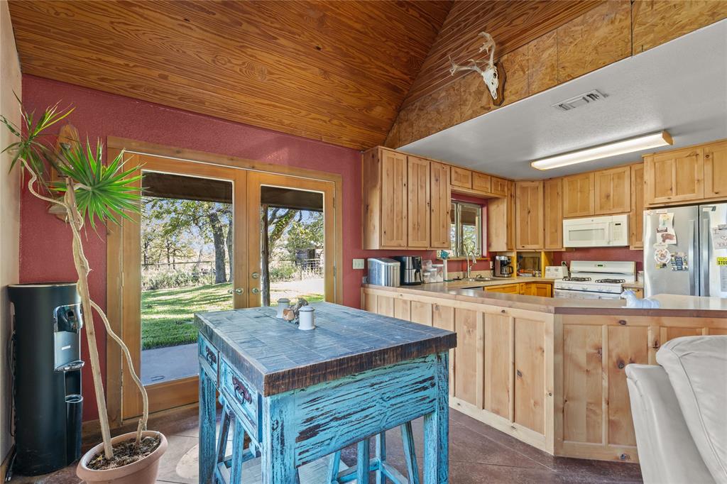 262 North Cheyenne Springtown, TX 76082 - Photo 3 of 35 a kitchen with a stove a sink dishwasher and a refrigerator