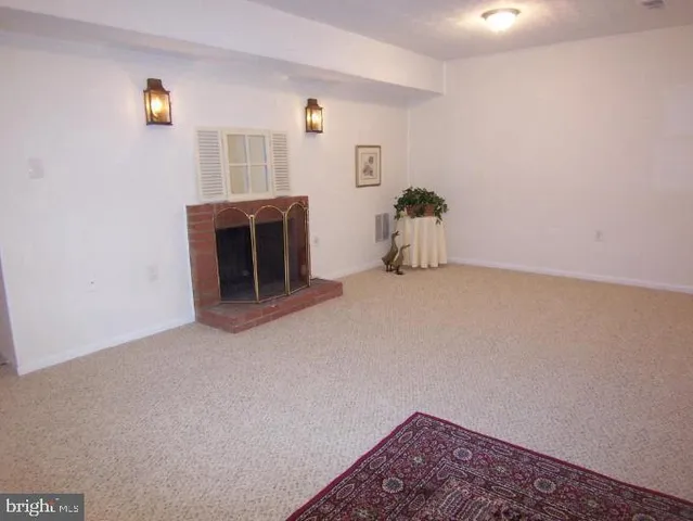 a view of an empty room with a fireplace