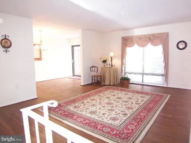 a view of a room with wooden floor and a window