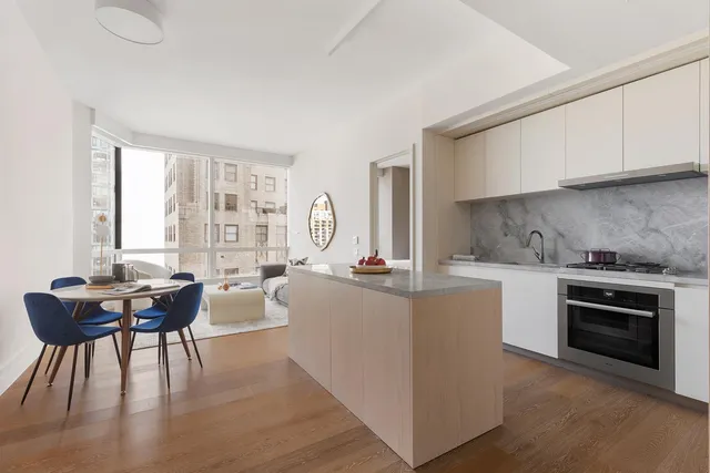 a kitchen with sink cabinets and dining table