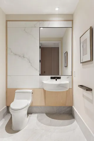 a bathroom with a toilet a sink and bathtub