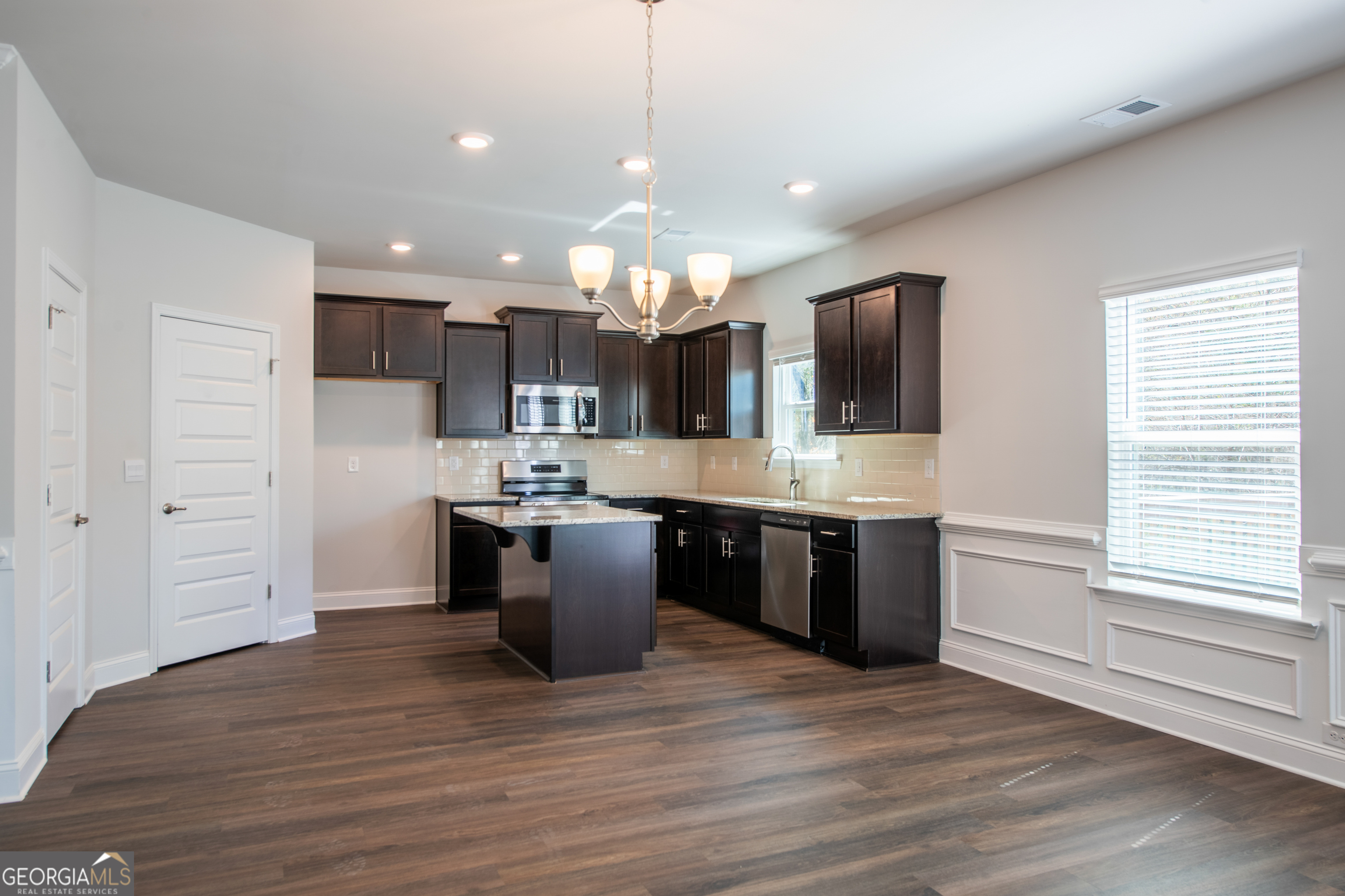 229 Carsons Walk Macon, GA 31206 - Photo 12 of 43 a large kitchen with a large counter top space a sink stainless steel appliances and cabinets