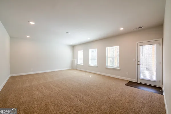 an empty room with windows and entrance