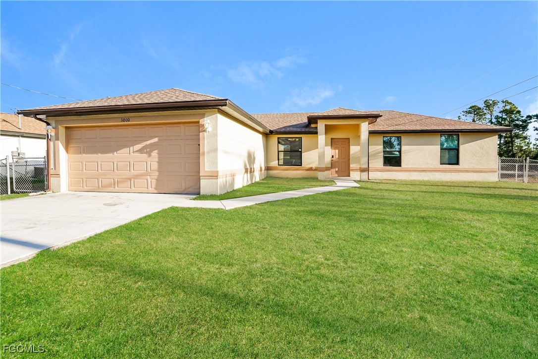 a front view of a house with a garden and yard