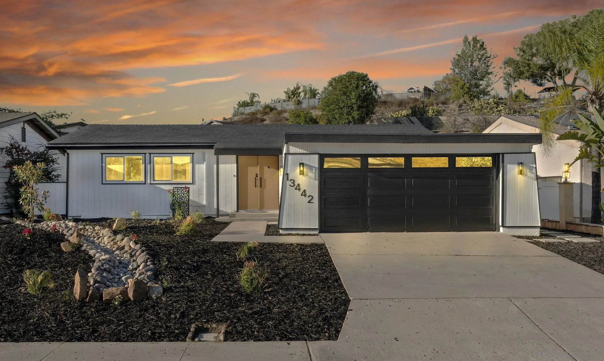 13442 Mountainside Drive Poway, CA 92064 - Photo 1 of 18 a front view of a house with a yard and garage