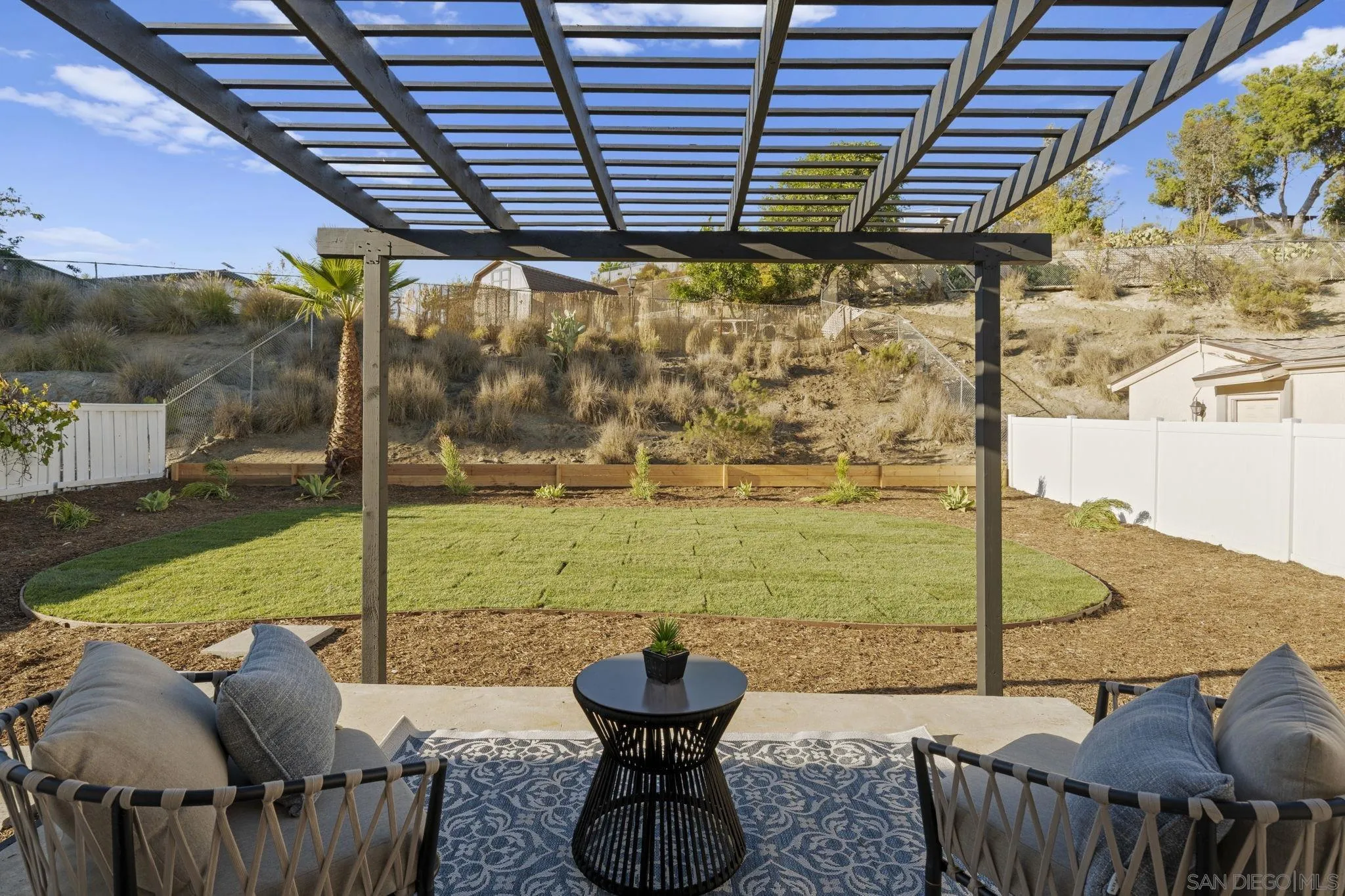 13442 Mountainside Drive Poway, CA 92064 - Photo 14 of 18 a view of a patio with a table chairs and a table