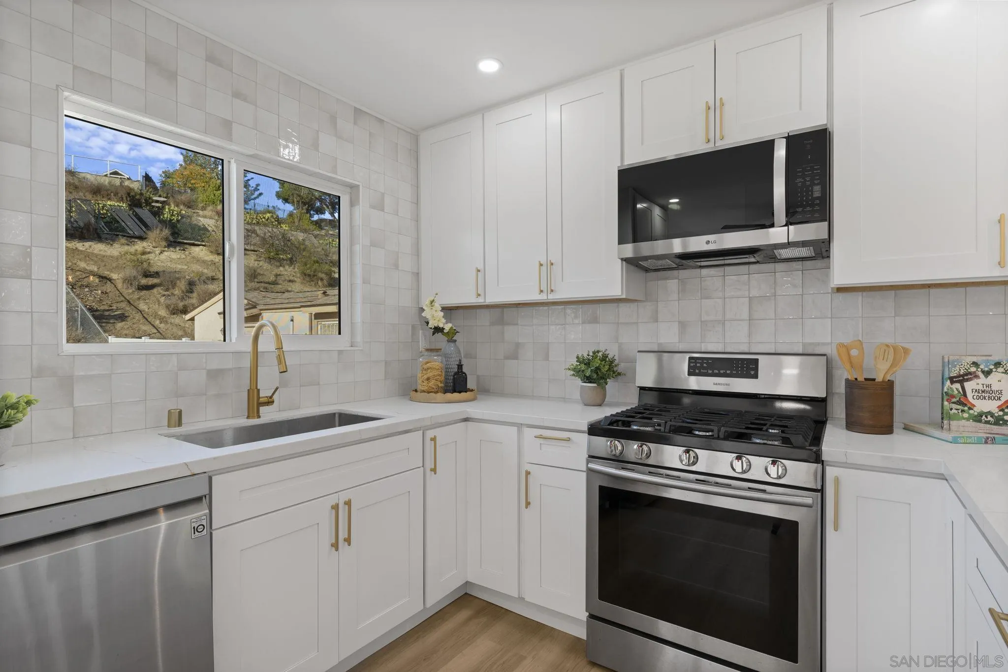 13442 Mountainside Drive Poway, CA 92064 - Photo 5 of 18 a kitchen with cabinets stainless steel appliances a sink and a stove
