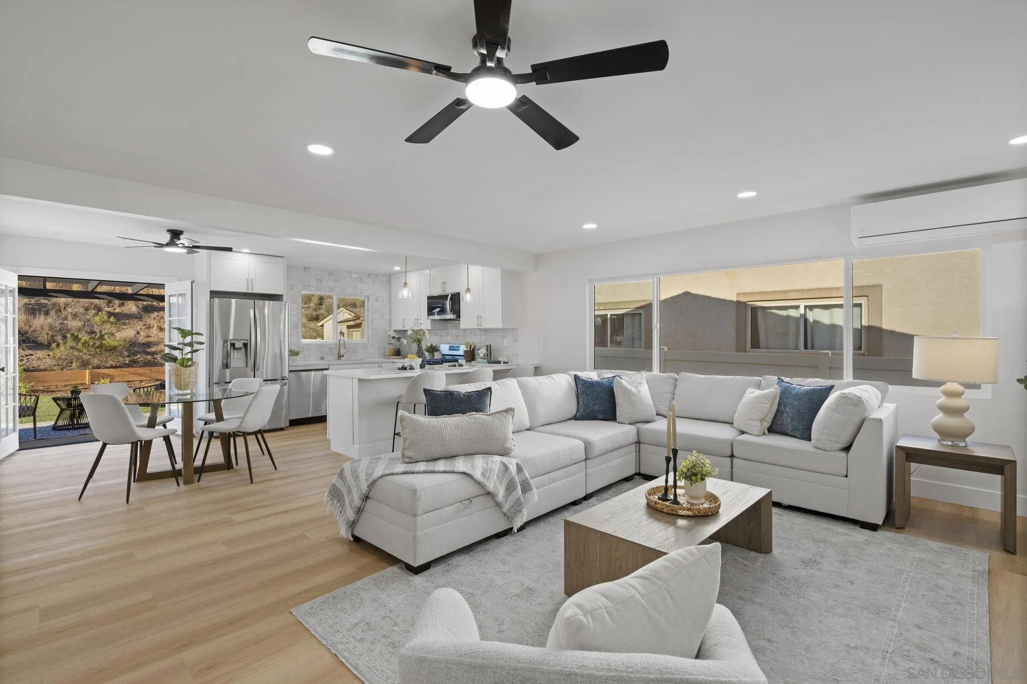 13442 Mountainside Drive Poway, CA 92064 - Photo 7 of 18 a living room with furniture kitchen view and a wooden floor