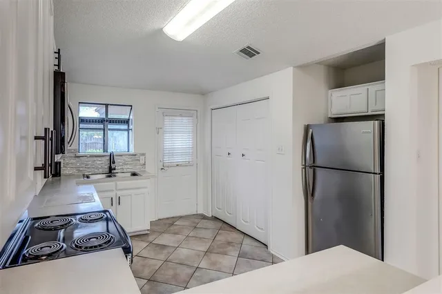 a room with two washing machine and refrigerator