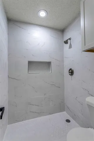 a bathroom with a toilet and shower