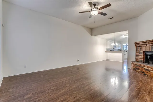 a kitchen with granite countertop a stove a sink and dishwasher with wooden floor