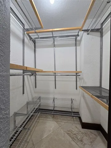 a bathroom with a granite countertop sink a toilet and a mirror