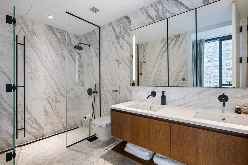 570 Broome Street, Unit 12B Manhattan, NY 10013 - Photo 7 of 17 a bathroom with a sink a toilet and shower