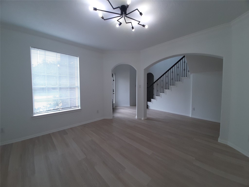 4214 Blue Sage Terrace Spring, TX 77388 - Photo 11 of 50 a view of an empty room with wooden floor ceiling fan and windows