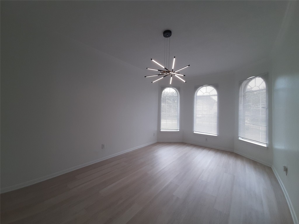 4214 Blue Sage Terrace Spring, TX 77388 - Photo 12 of 50 an empty room with wooden floor fan and windows