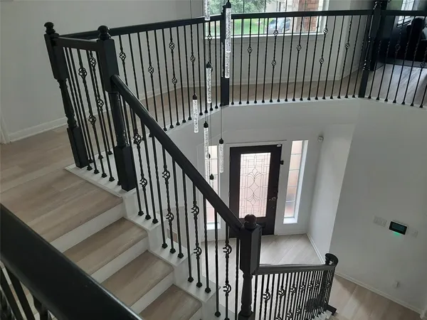 a view of a hallway with wooden floor and entryway