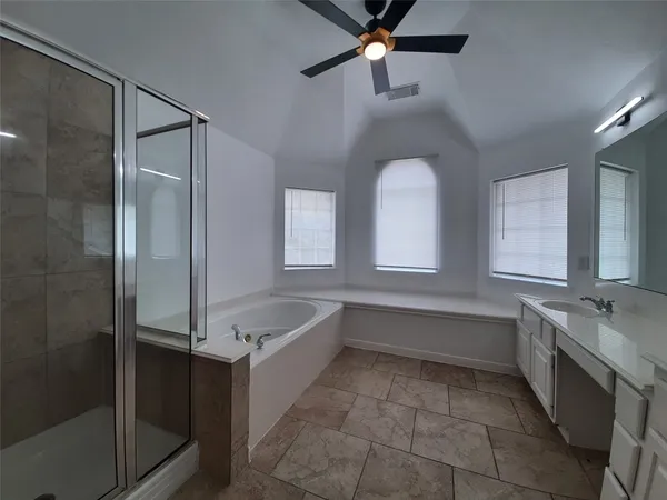 a bathroom with sinks mirror and a bathtub