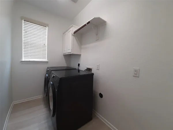 a view of storage and utility room with a window