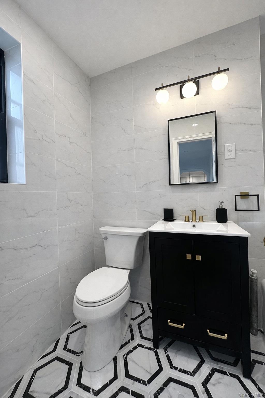 4810 Boston Post Road, Unit 4E Pelham, NY 10803 - Photo 11 of 26 a bathroom with a toilet sink vanity and mirror