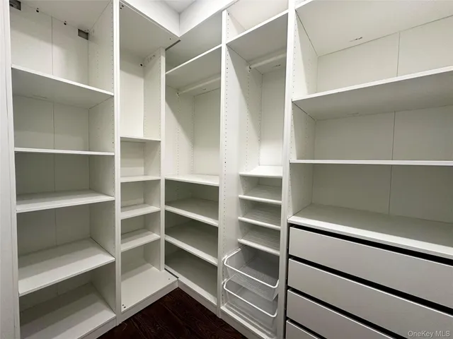 a view of walk in closet with empty racks