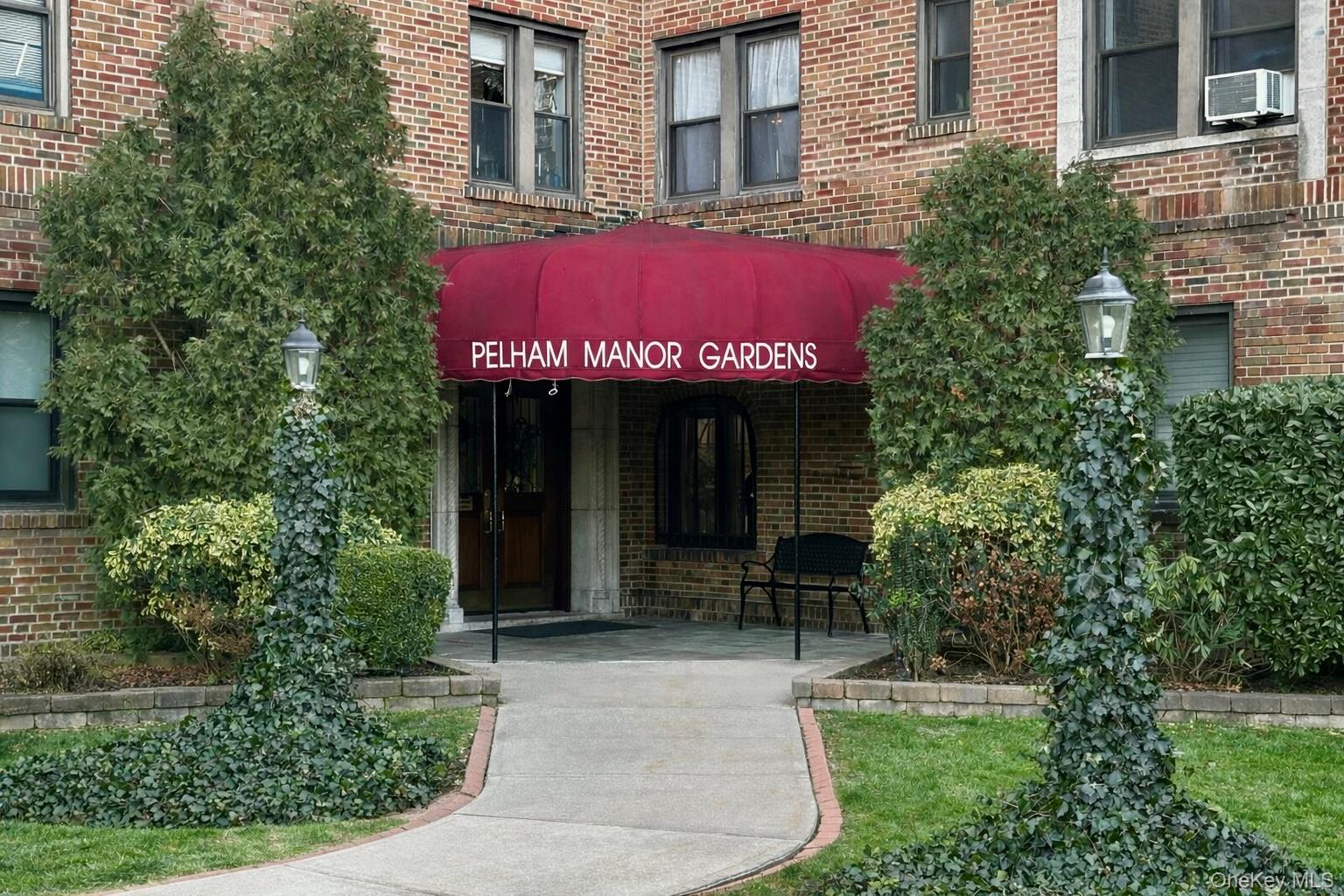 4810 Boston Post Road, Unit 4E Pelham, NY 10803 - Photo 20 of 26 front view of a brick house with a yard