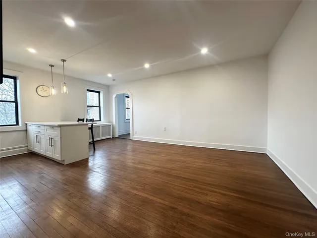 a view of a kitchen with a sink and a large window