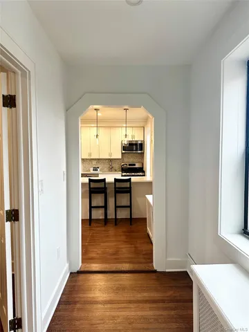 a view of a workspace with furniture and a kitchen