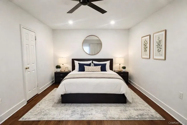 a bathroom with a toilet sink vanity and mirror