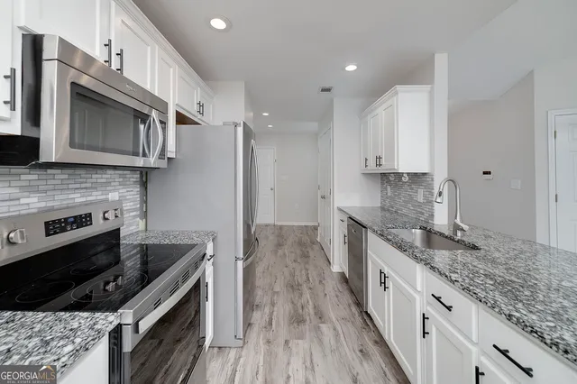 a view of an empty room and wooden floor
