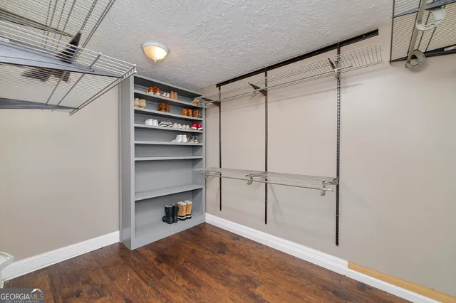 a view of a livingroom with a ceiling fan and wooden floor