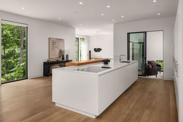 a dining room with furniture and large windows