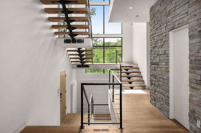 a living room with furniture tv and a large window