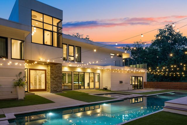 a view of a city with lush green forest