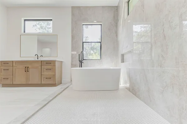 a view of a bathroom with bathtub and shower