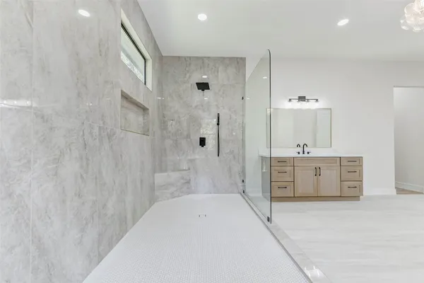 a bathroom with a sink a mirror and a shower