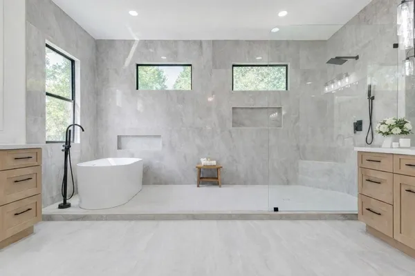 a bathroom with a bathtub a toilet and a shower
